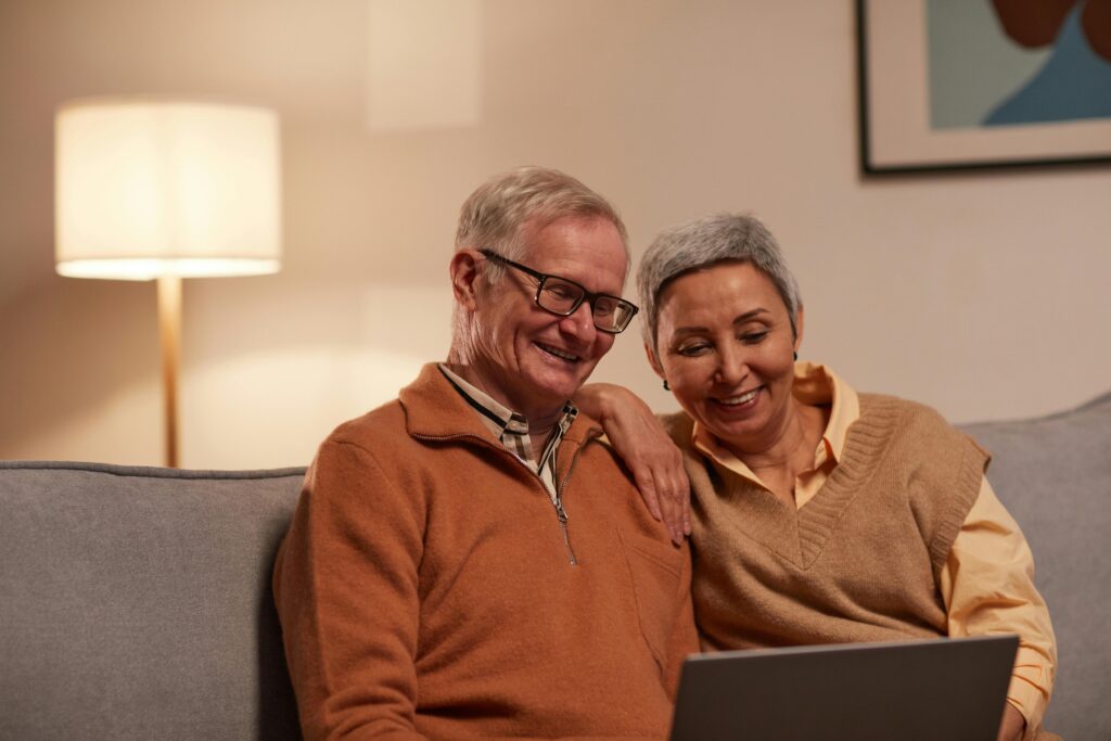 pexels-photo-6787970-6787970 Senior couple enjoying time together on laptop indoors, smiling and relaxed.
